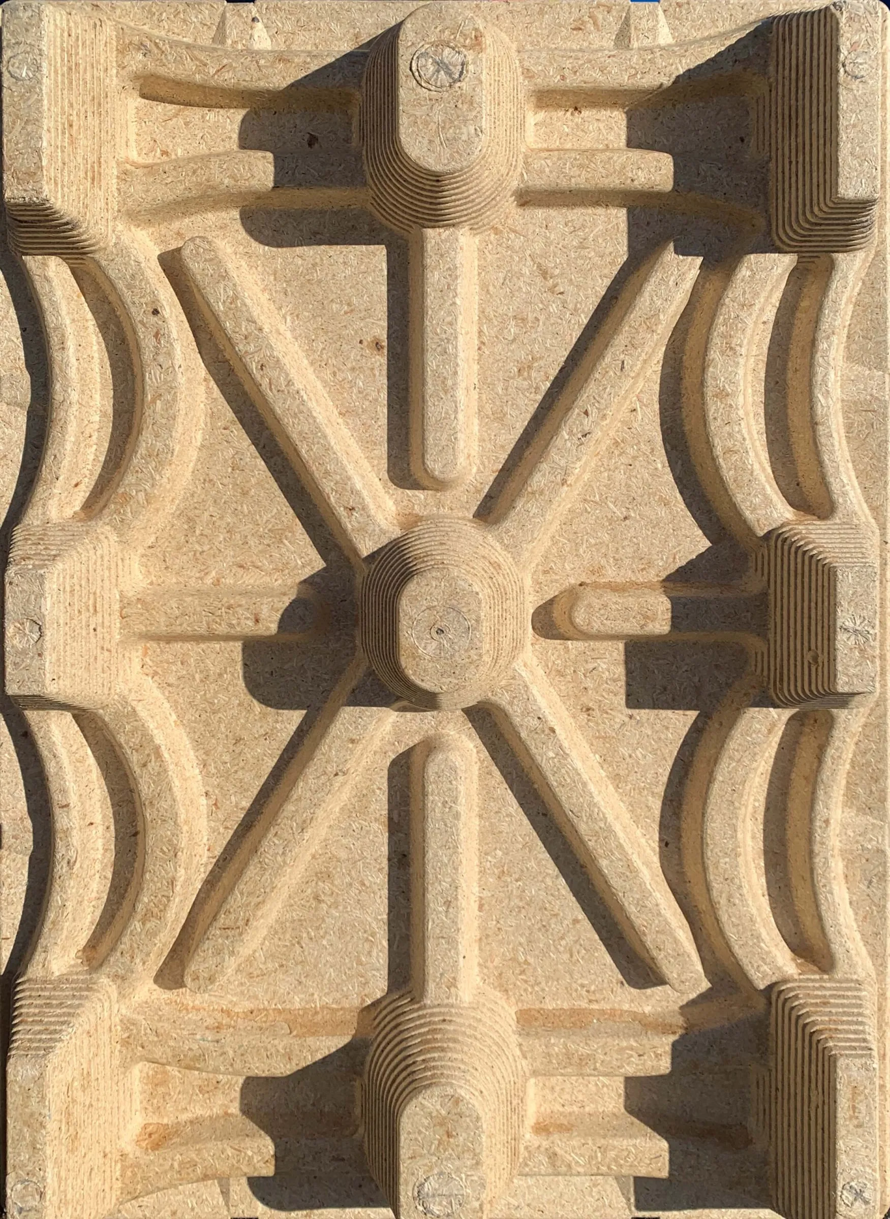 Close-up of a molded wood-fibre pallet or carton base with a sculpted star-like relief pattern